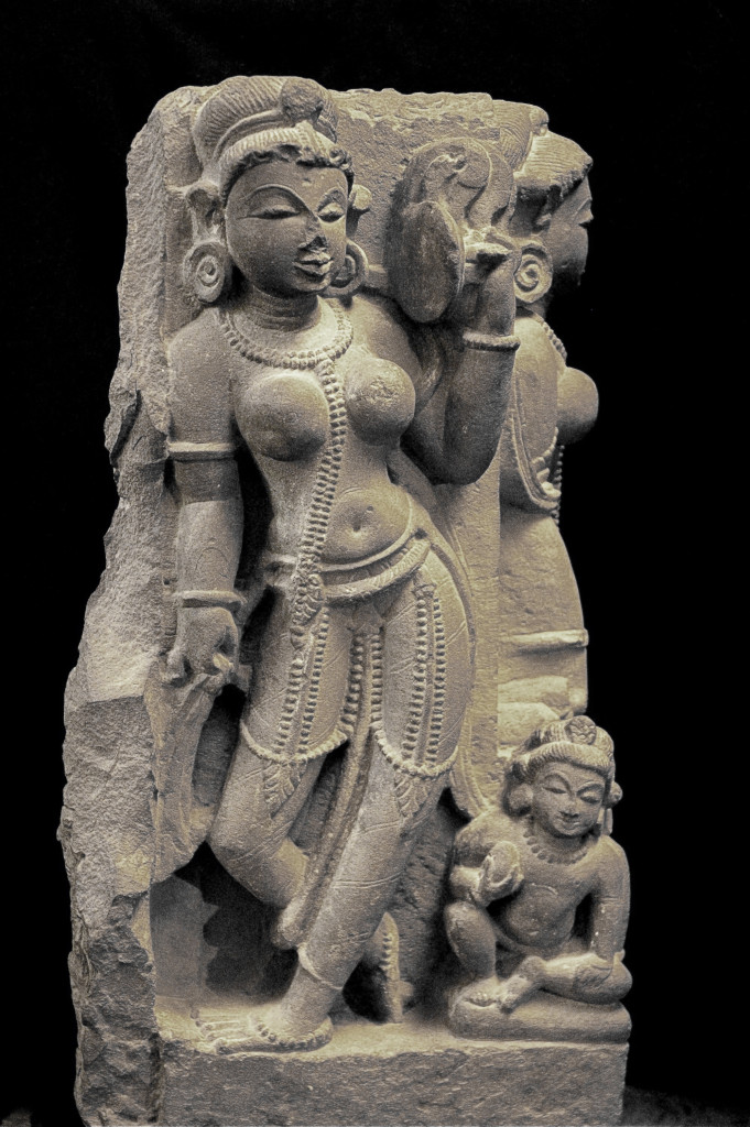 A sandstone sculpture of two celestial beauties looking into a mirror