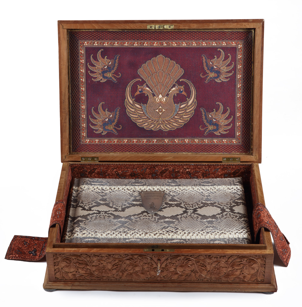 An important commemorating Indonesian carved Sawo wood box containing a luxurious photo album