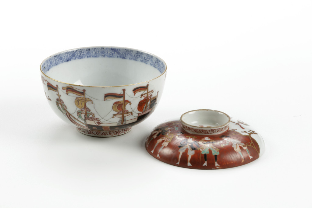 A Japanese Arita porcelain Imari-style vowl and cover with Dutchmen