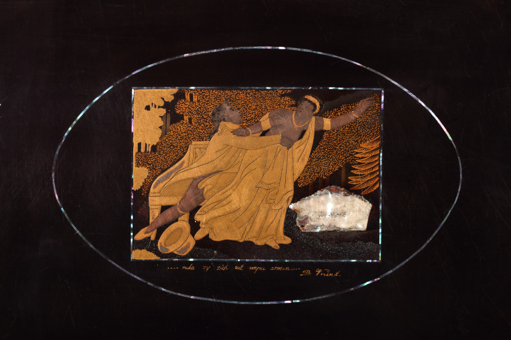 A Japanese lacquer writing box decorated with a man trying to withhold a woman from fleeing, titled '...rukt zij zich uit mijne armen... De Vriend’ (...she tears herself out of my arms...The Friend)