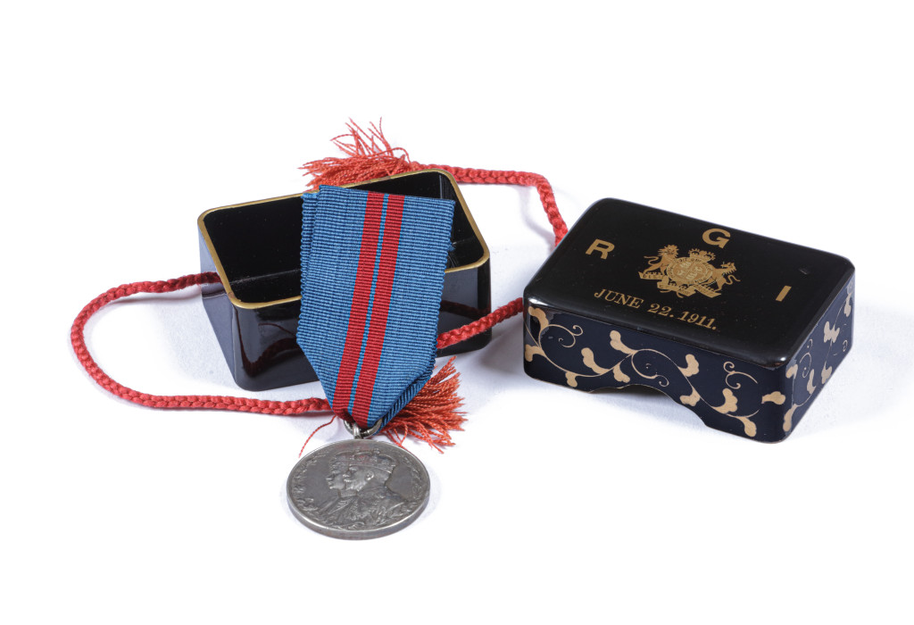 A small Japanese lacquer box with on the lid the English Royal coat-of-arms, R G I, and June 22. 1911
