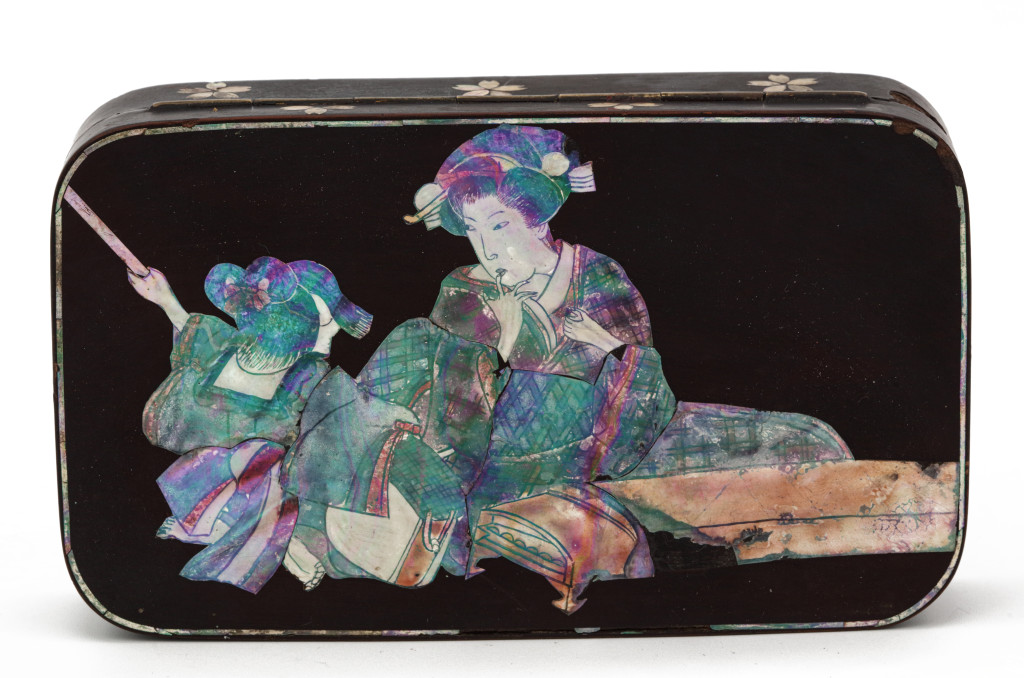 A Japanese lacquered and mother-of-pearl inlaid copper tobacco box with a scene of two ladies playing the koto and the shamisen