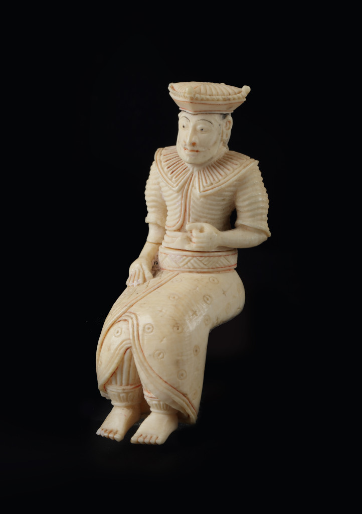A small ivory sculpture of a seated Sri Lankan king