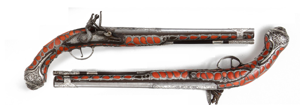 An extremely rare and splendid Algerian set of silver and red coral inlaid pistols and a toe-lock gun