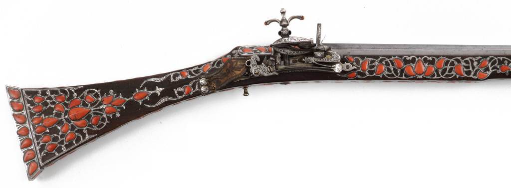 An extremely rare and splendid Algerian set of silver and red coral inlaid pistols and a toe-lock gun
