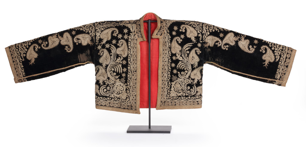 A short black velvet, corded gold-embroidered, red cotton-lined vest with sleeves