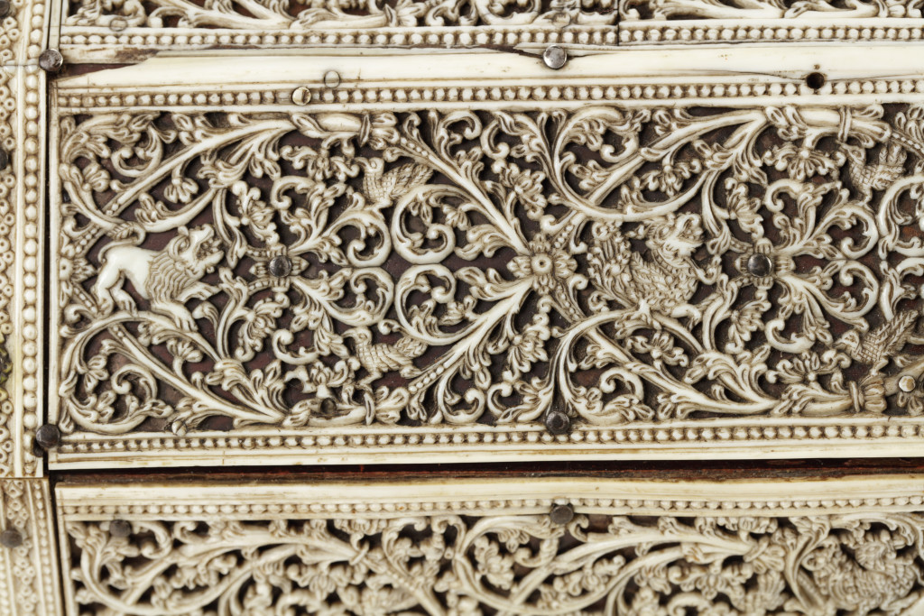A Sri Lankan openwork-carved ivory and mica covered wood box with trapezoid-shaped lid and silver mounts