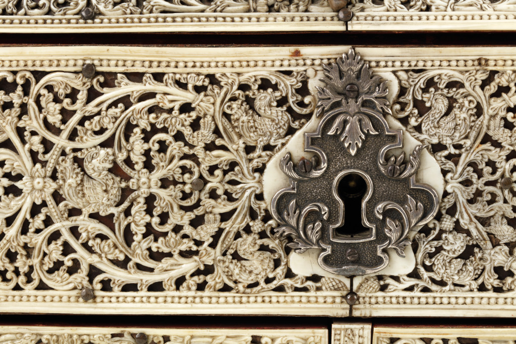 A Sri Lankan openwork-carved ivory and mica covered wood box with trapezoid-shaped lid and silver mounts