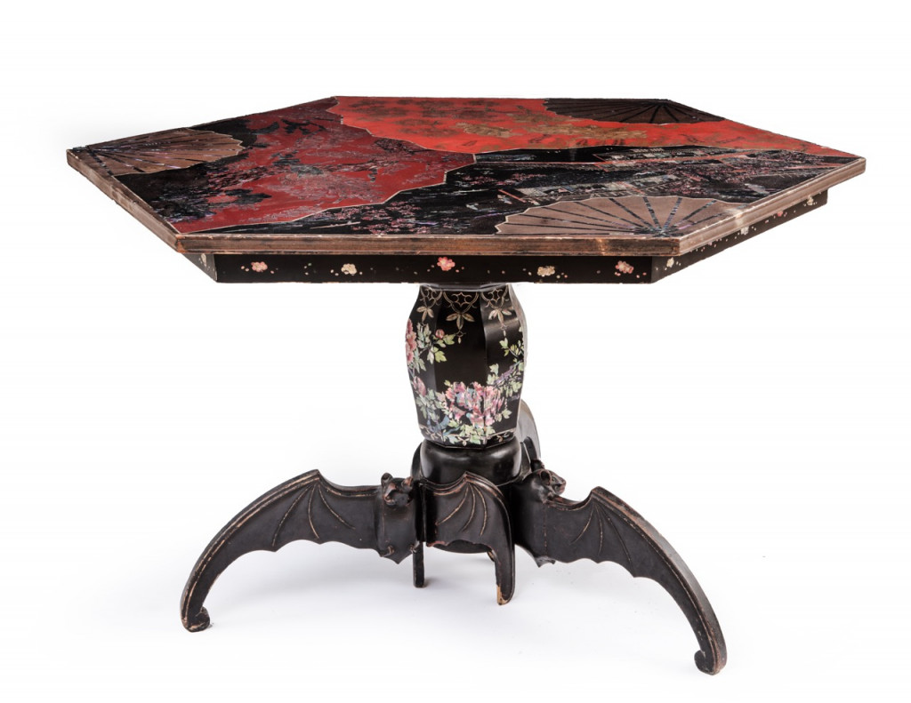A Japanese export lacquer tripod table with feet shaped like bats