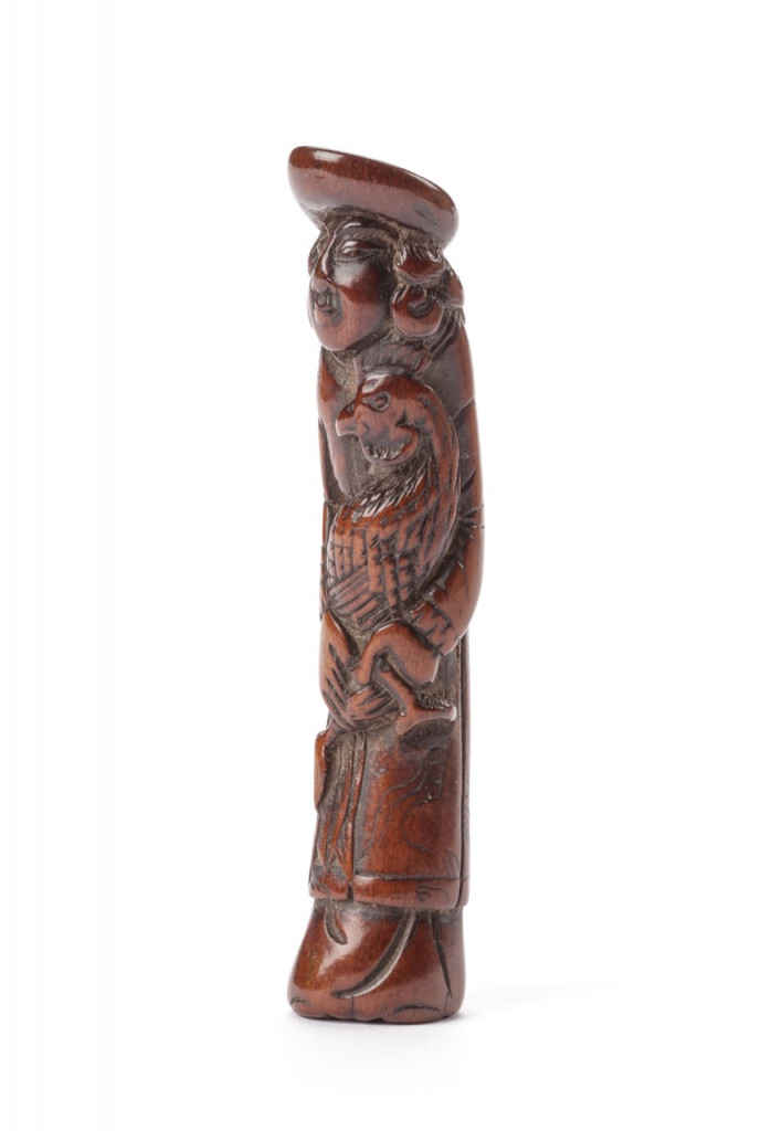A rare bone netsuke of a Dutchman with a cockerel