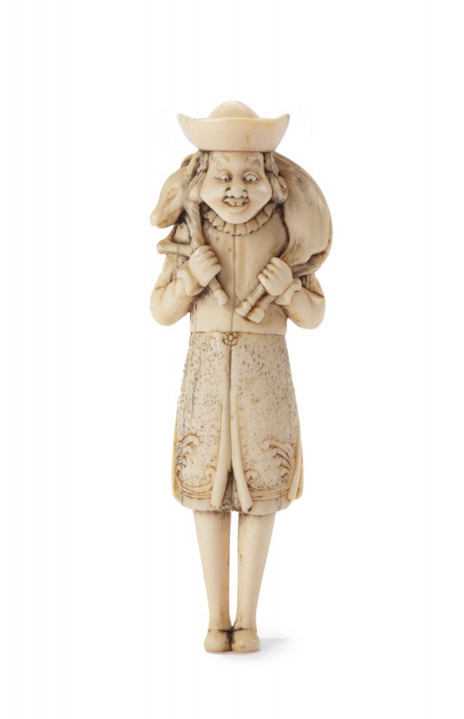 A superb Japanese ivory netsuke of a Dutchman carrying a boar slung over his shoulder