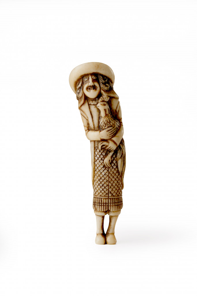 An antler and black horn netsuke of a tall Dutchman