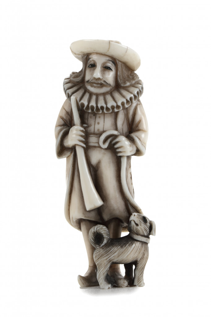 An ivory netsuke of a Dutchman with a dog on a lead, signed Masatoshi