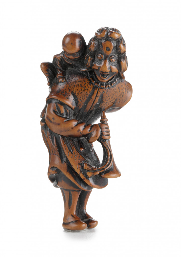 A wooden netsuke of a Dutchman with karako and trumpet