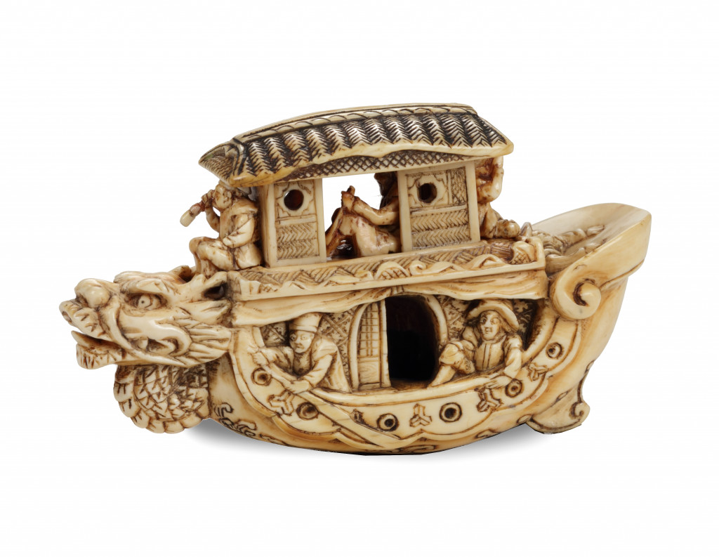A large netsuke/okimono of a ship with Dutchmen