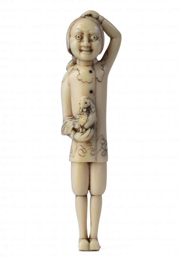 An ivory netsuke of a Dutchman holding a cockerel and scratching his head