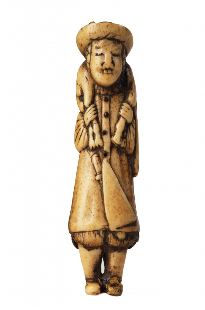 A stag antler netsuke of a Dutchman with a deer