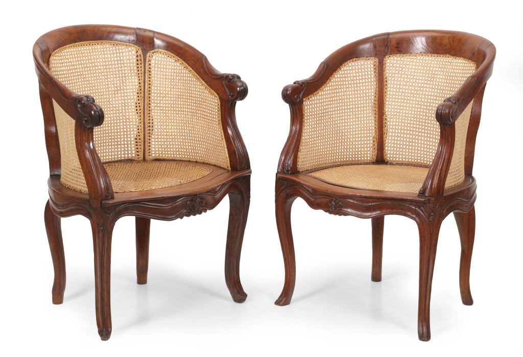 A set of four padouk, djati and cane Dutch-colonial Indonesian round-back chairs