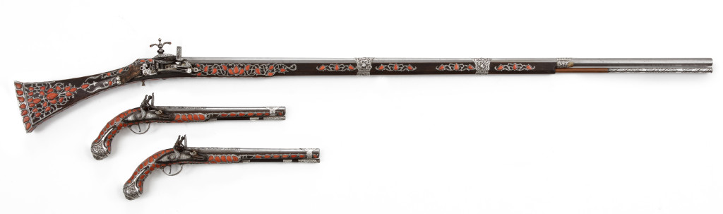 An extremely rare and splendid Algerian set of silver and red coral inlaid pistols and a toe-lock gun