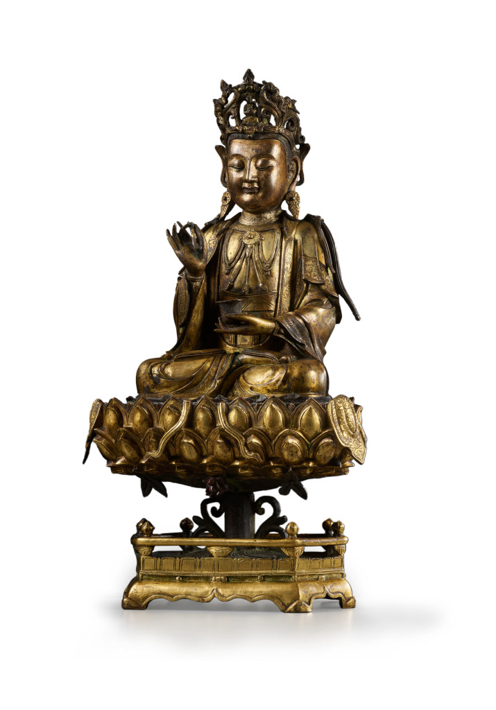 A Chinese gilt-bronze sculpture of Guanyin on a lotus throne pedestal