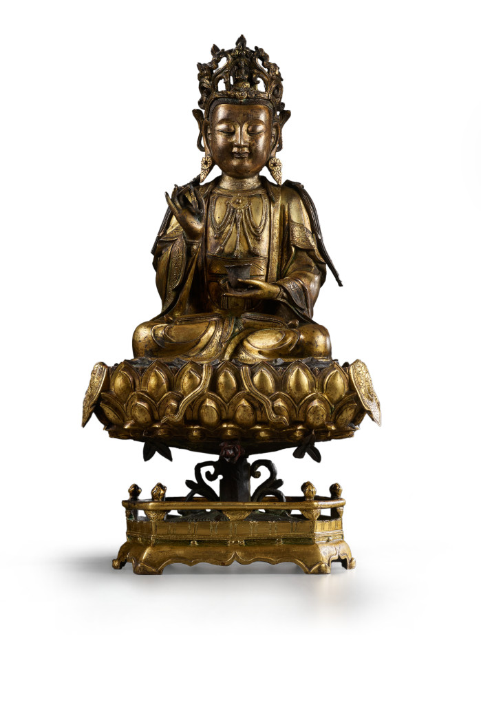A Chinese gilt-bronze sculpture of Guanyin on a lotus throne pedestal