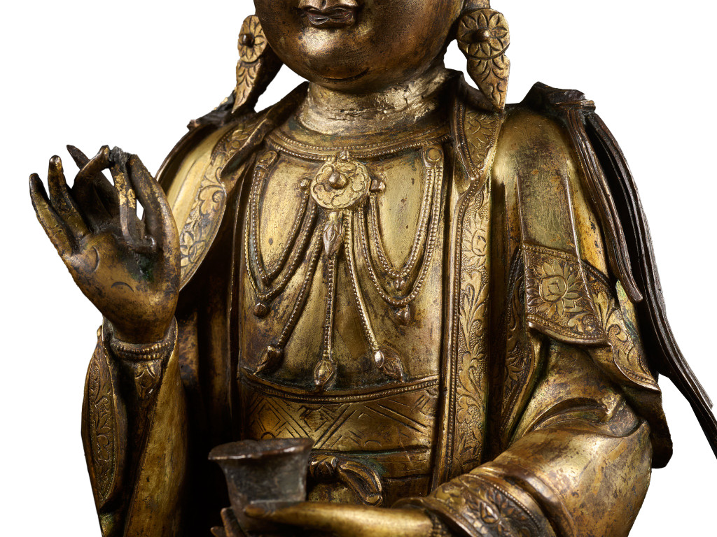 A Chinese gilt-bronze sculpture of Guanyin on a lotus throne pedestal