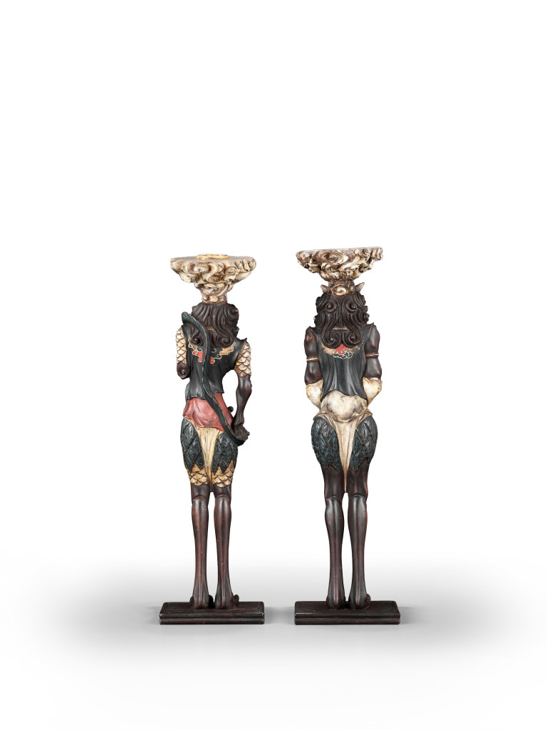 A pair of Japanese painted and lacquered wood candlesticks in the form of oni