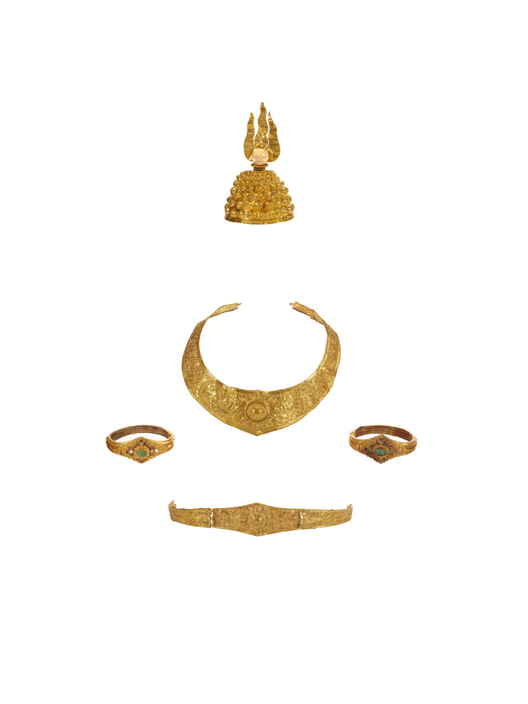 An ancient Javanese royal gold part adornment set for a queen, consisting of a topknot crown with a rock-crystal finial, a breast ornament, a belt, and a pair of gem-set upper-arm bracelets, each in repoussé high-carat gold