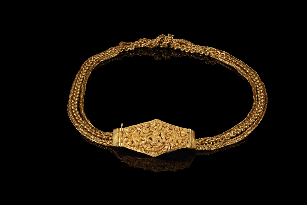 An ancient Javanese solid high-carat near-pure gold pendant on a three-strand chain