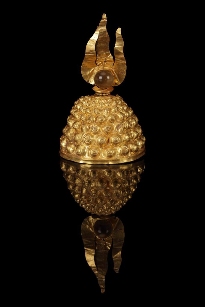 An ancient Javanese royal gold part adornment set for a queen, consisting of a topknot crown with a rock-crystal finial, a breast ornament, a belt, and a pair of gem-set upper-arm bracelets, each in repoussé high-carat gold