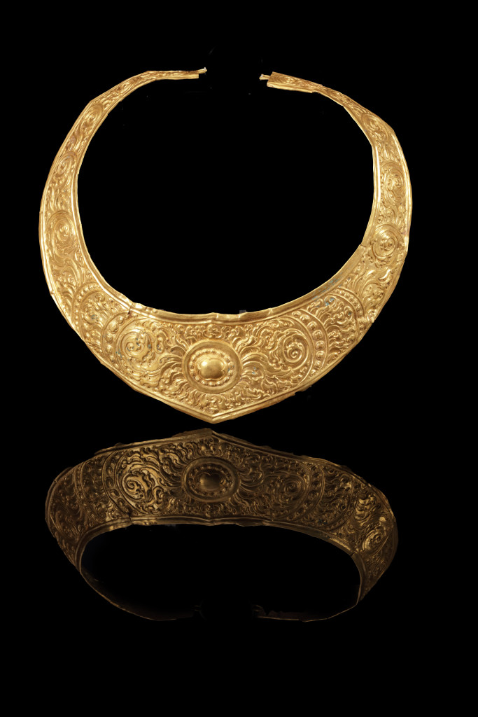An ancient Javanese royal gold part adornment set for a queen, consisting of a topknot crown with a rock-crystal finial, a breast ornament, a belt, and a pair of gem-set upper-arm bracelets, each in repoussé high-carat gold