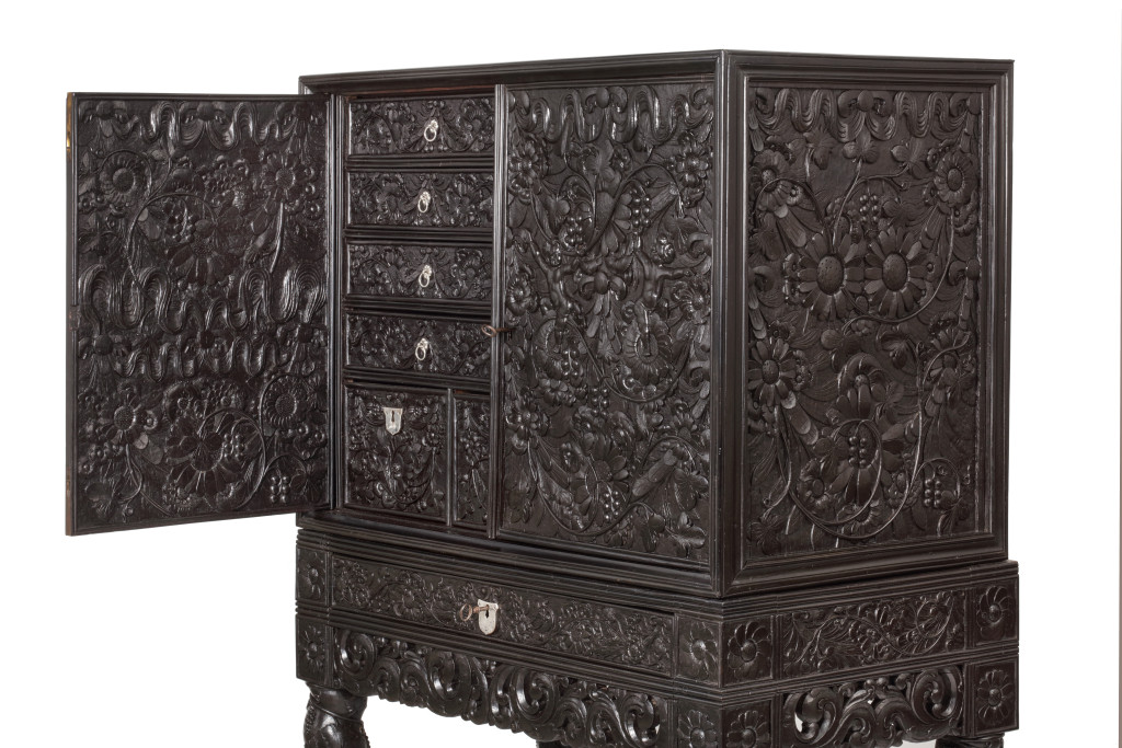 A Dutch-colonial Indonesian ebony cabinet on stand