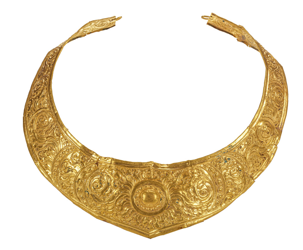 An ancient Javanese royal gold part adornment set for a queen, consisting of a topknot crown with a rock-crystal finial, a breast ornament, a belt, and a pair of gem-set upper-arm bracelets, each in repoussé high-carat gold
