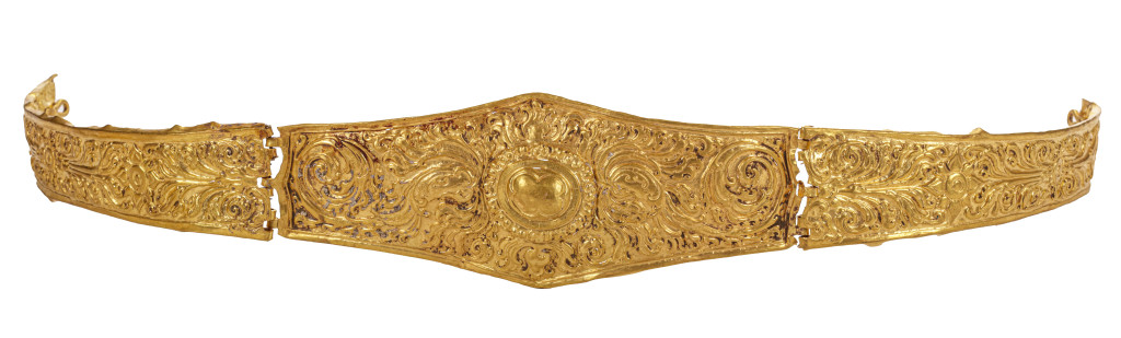 An ancient Javanese royal gold part adornment set for a queen, consisting of a topknot crown with a rock-crystal finial, a breast ornament, a belt, and a pair of gem-set upper-arm bracelets, each in repoussé high-carat gold