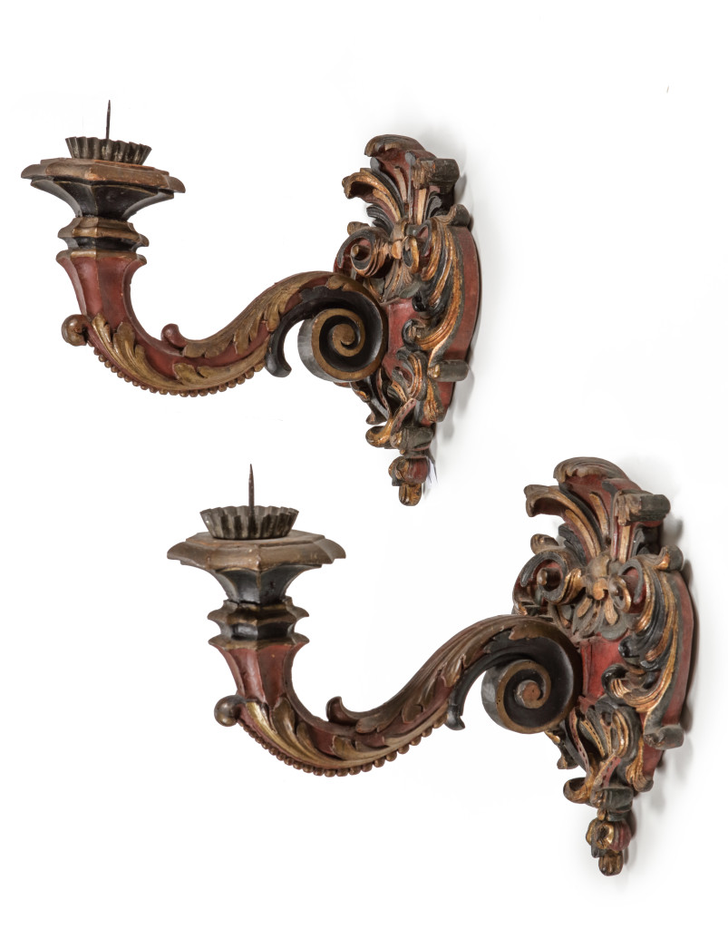 A fine pair of Indonesian red, black and gold lacquered djati wood wall lights