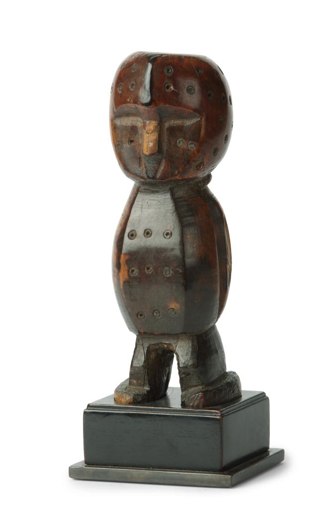An ivory Lega lginga figure with signs of medicinal use