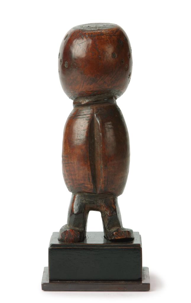 An ivory Lega lginga figure with signs of medicinal use