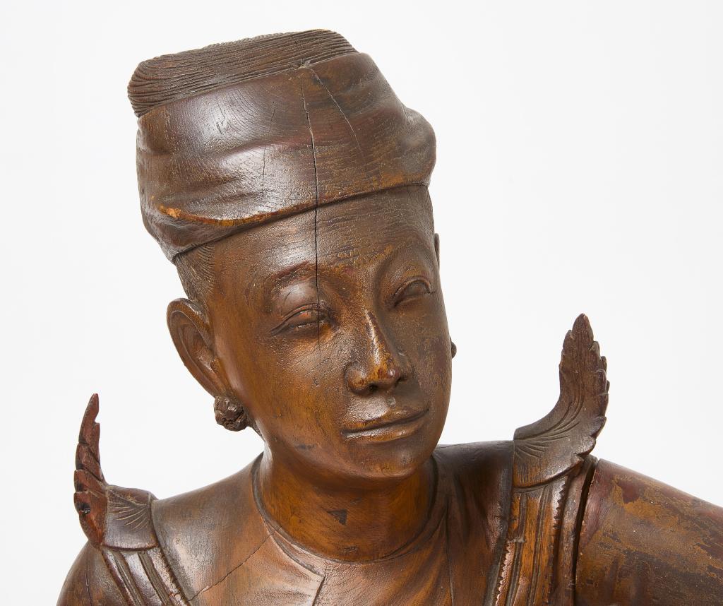 A large Mandalay teakwood altar sculpture of a guardian attendant