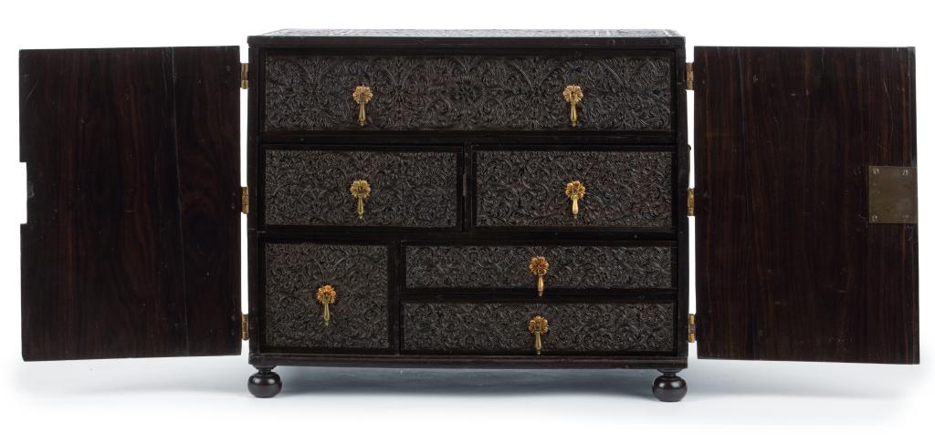 An Indian low-relief carved ebony cabinet with brass mounts
