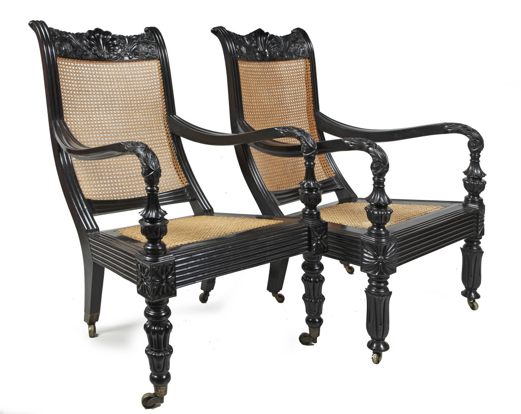 A pair of Sri Lankan ebony and cane easy chairs
