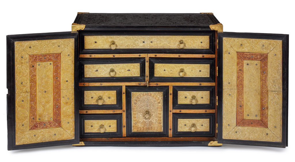 A two-door low-relief carved ebony and ivory cabinet with gilt-brass mounts