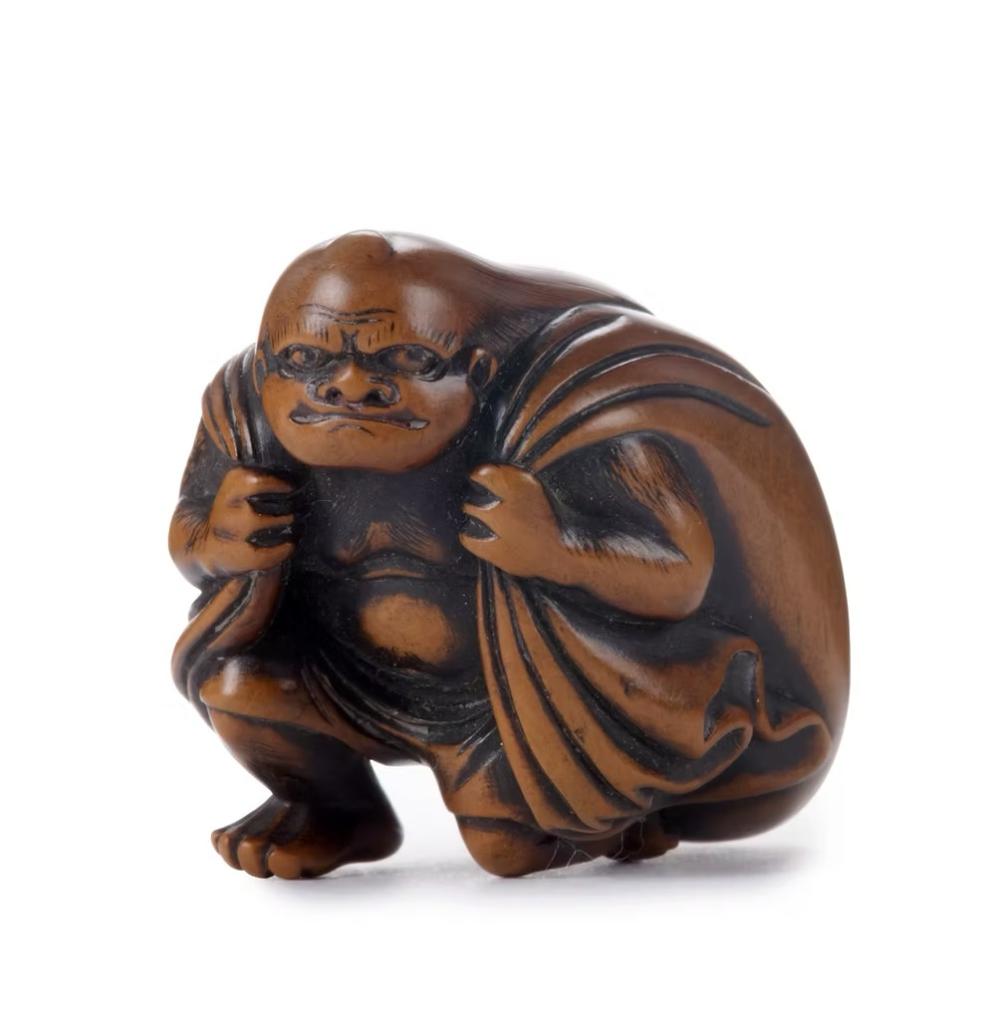 A wood netsuke of Futen with his sack by Shuzan