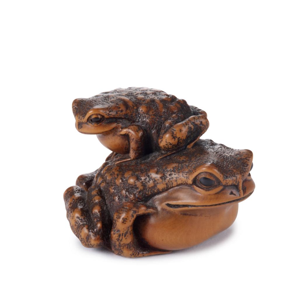 A kaki wood netsuke of a toad and its young by Masanao