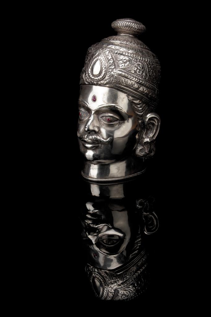 A large silver Shiva head