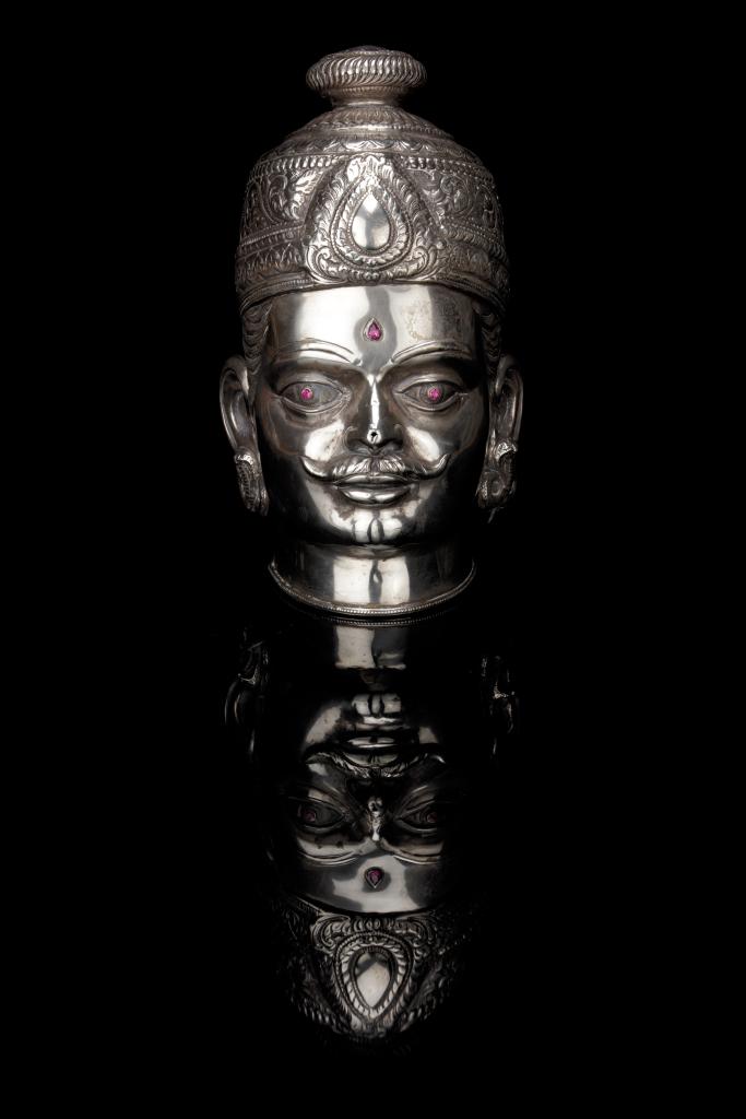 A large silver Shiva head