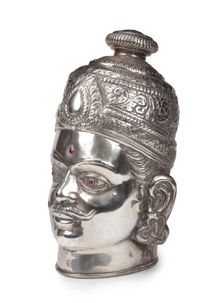 A large silver Shiva head