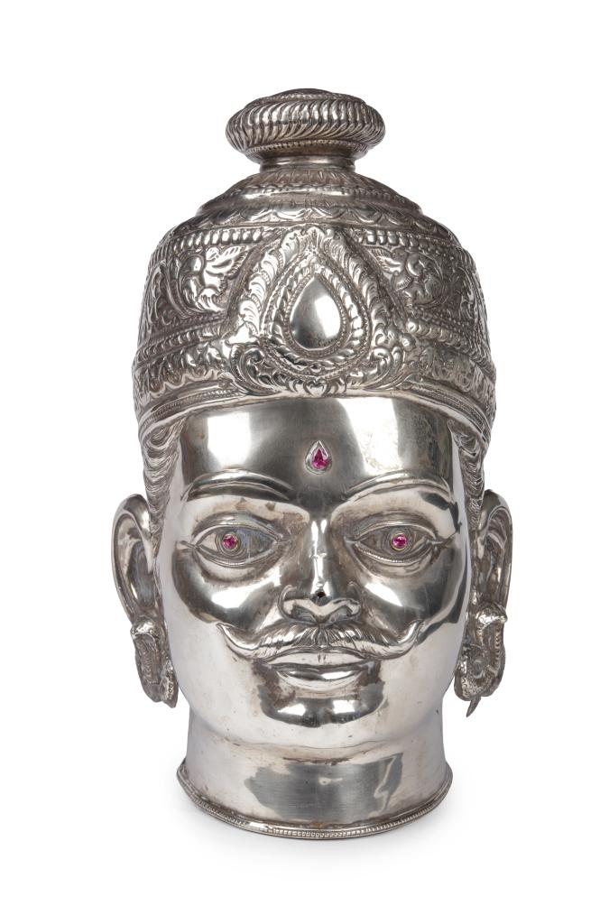 A large silver Shiva head