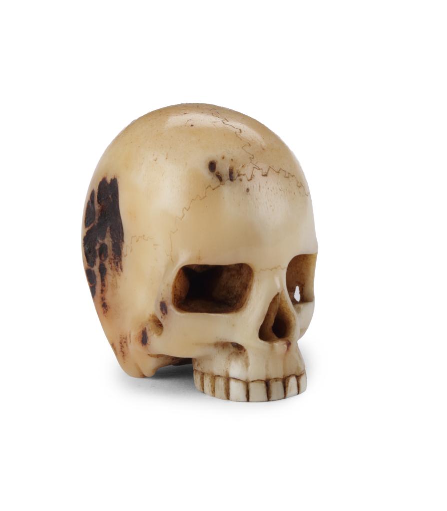 A fine antler netsuke of a skull