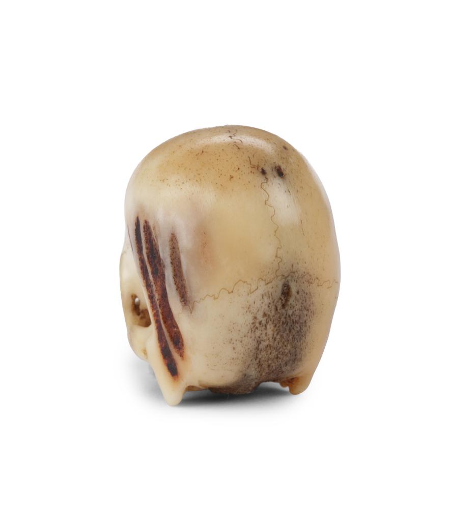 A fine antler netsuke of a skull