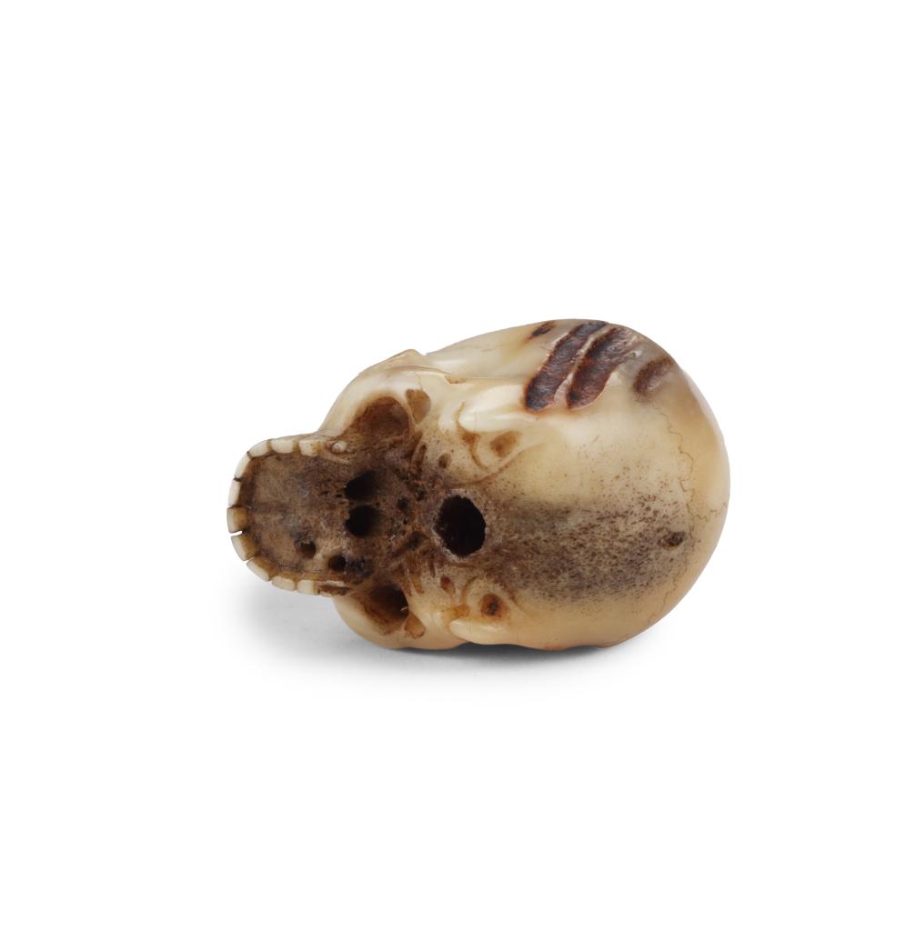 A fine antler netsuke of a skull